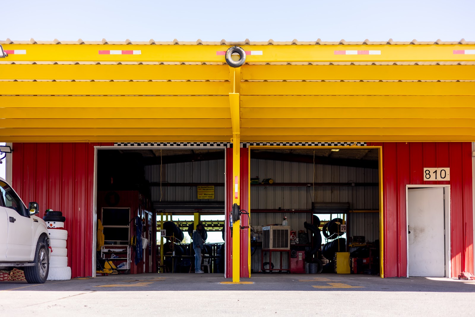 Red and yellow open service bays at Medina Tire and Mechanic Shop.